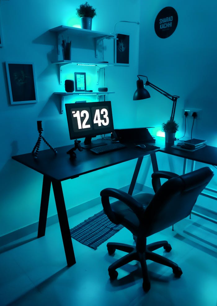 Contemporary home office setup featuring blue LED lighting and sleek design elements.